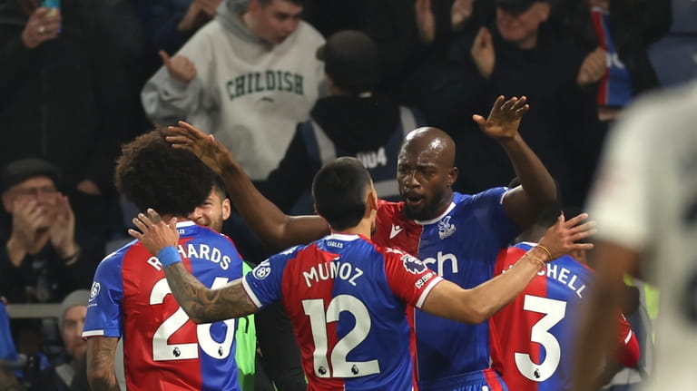Crystal Palace's Jean-Philippe Mateta, right, celebrates with teammates after scoring...