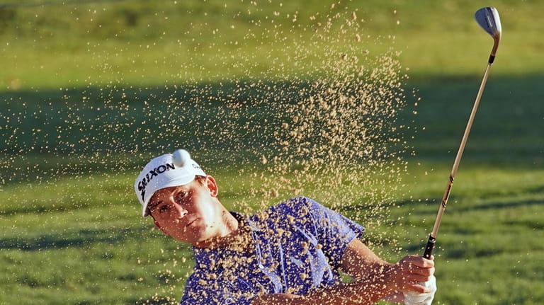 Smylie Kaufman hits out of a green side bunker on...