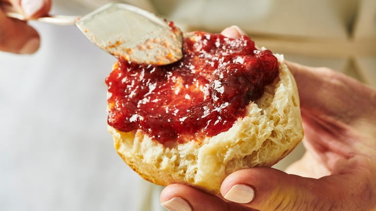 This image shows a strawberry jam recipe atop of a...