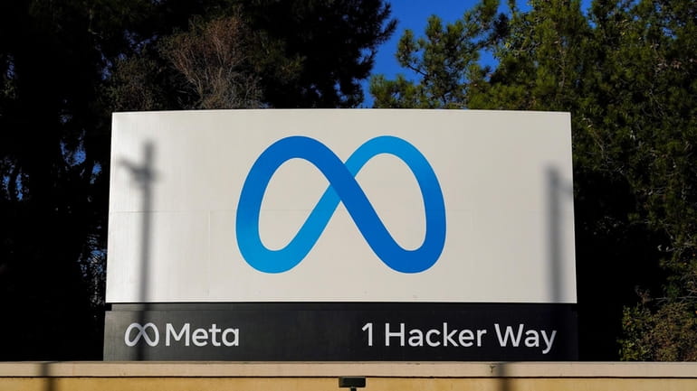 Meta's logo is seen on a sign at the company's...