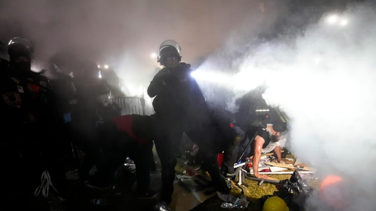 Police enter an encampment set up by pro-Palestinian demonstrators on...