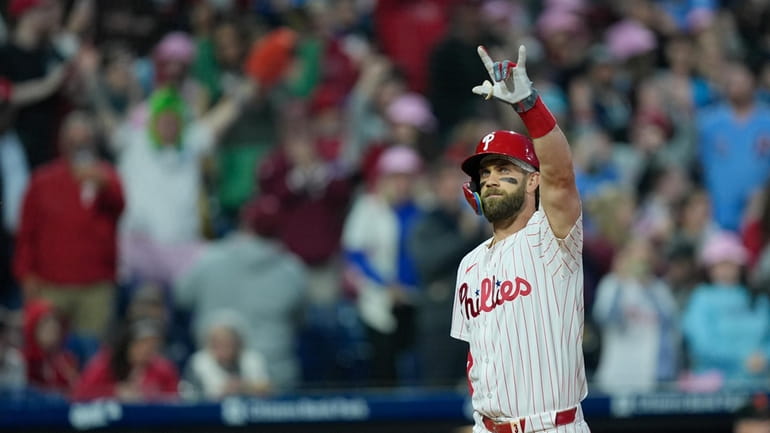 Philadelphia Phillies' Bryce Harper celebrates after hitting a three-run home...
