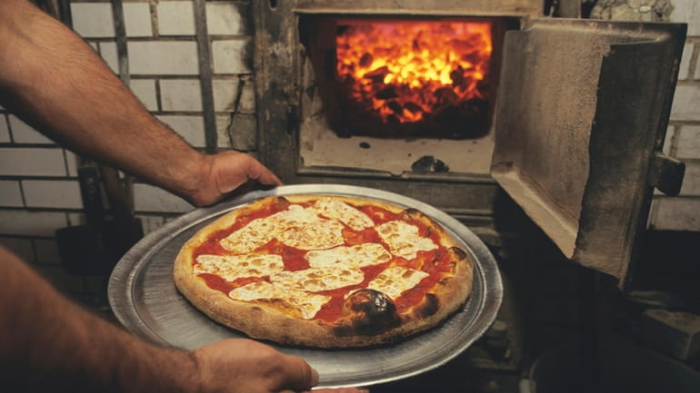 Pizza cooked in a brick oven at Lombardi's pizza restaurant...