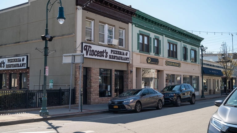 Businesses along Atlantic Avenue are nestled between the LIRR and...