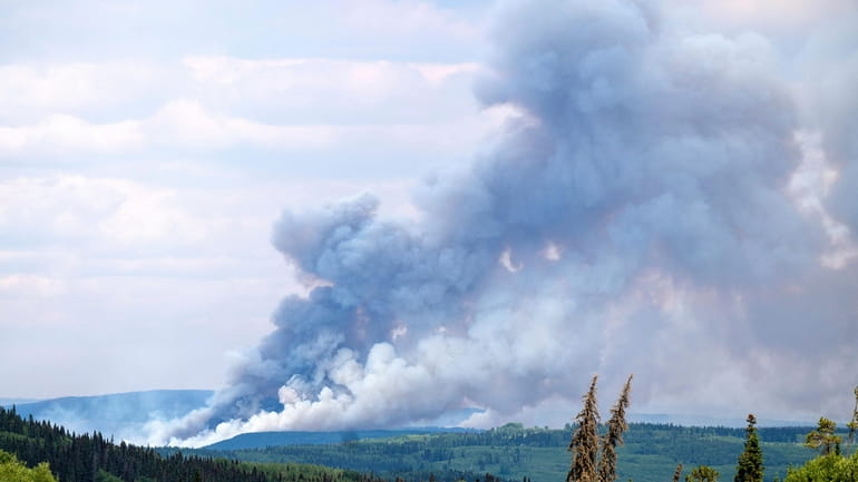 Smoke billows from the Donnie Creek wildfire burning north of...