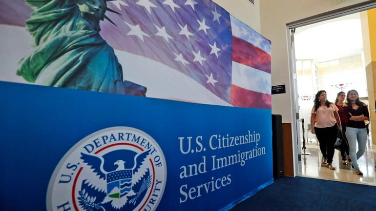 People arrive before the start of a naturalization ceremony at...