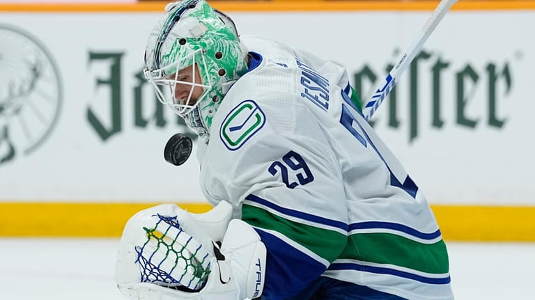 Vancouver Canucks goaltender Casey DeSmith (29) warms up before the...