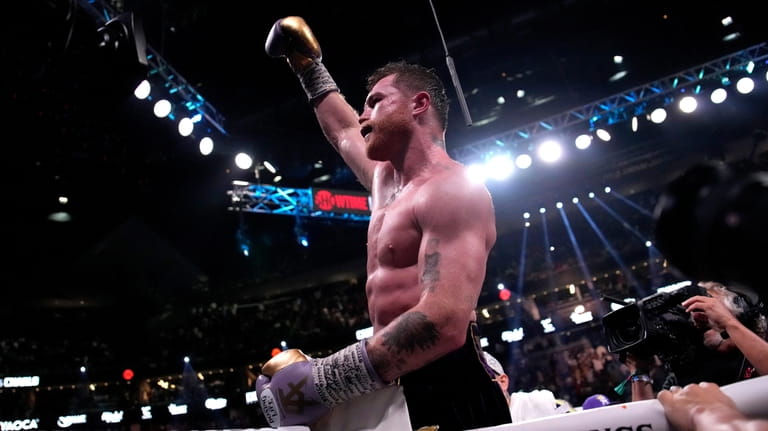 Canelo Alvarez, of Mexico, celebrates after defeating Jermell Charlo in...