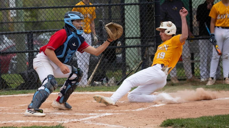 Oyster Bay's Tommy Rizzuto beats the throw to Wheatley catcher...