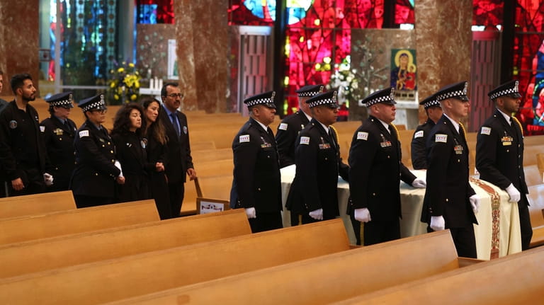 The family of Chicago police Officer Luis Huesca, including his...