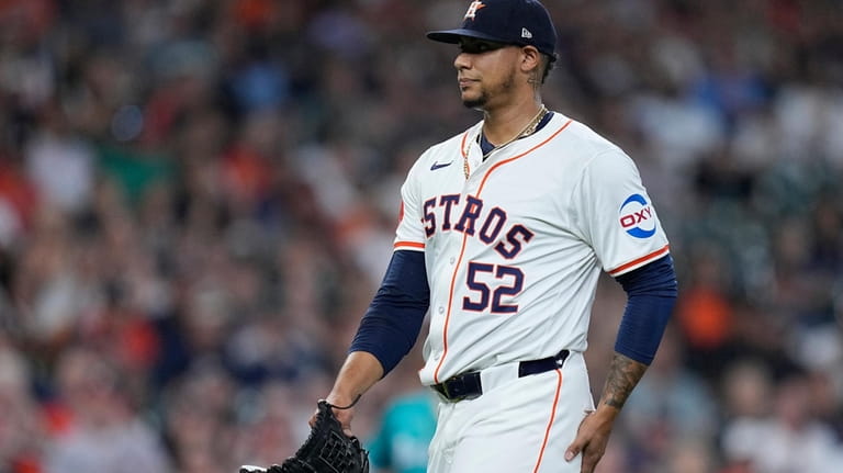 Houston Astros pitcher Bryan Abreu walks to the dugout after...