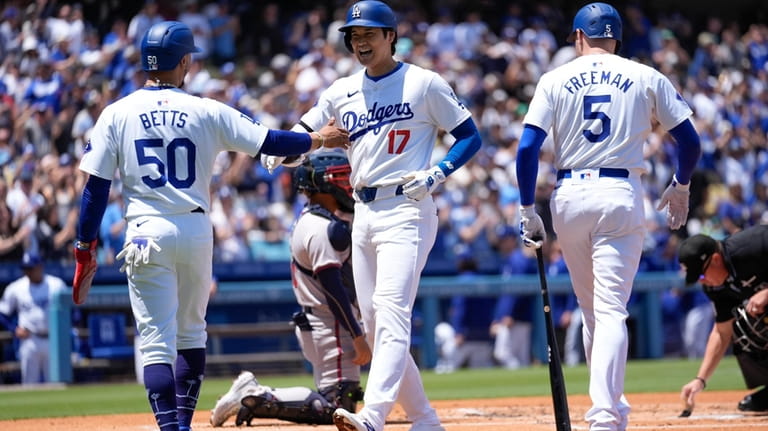 Los Angeles Dodgers designated hitter Shohei Ohtani (17) celebrates with...