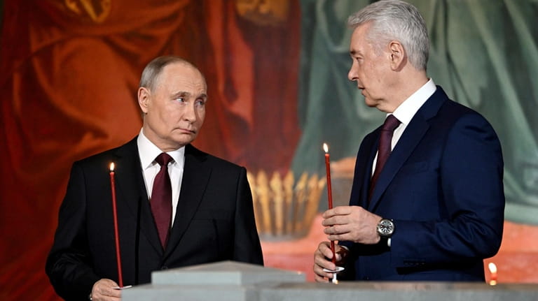Russian President Vladimir Putin, left, and Moscow Mayor Sergei Sobyanin...