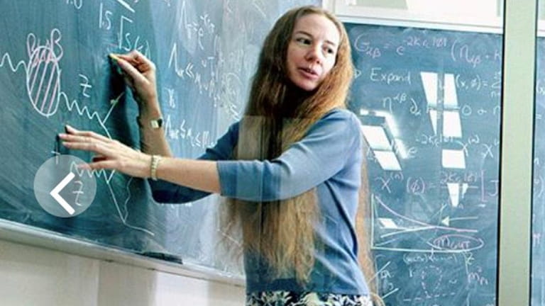 JoAnne Hewett at a blackboard at the SLAC National Accelerator Laboratory, a federal...