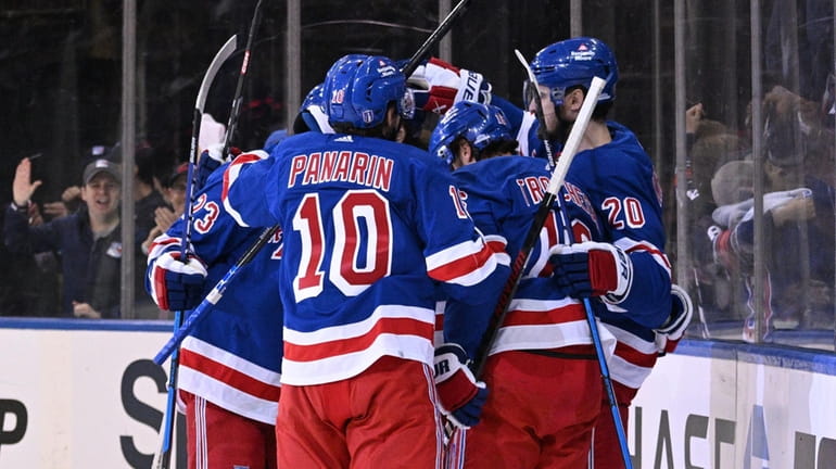 Rangers players celebrate a second goal by center Mika Zibanejad...