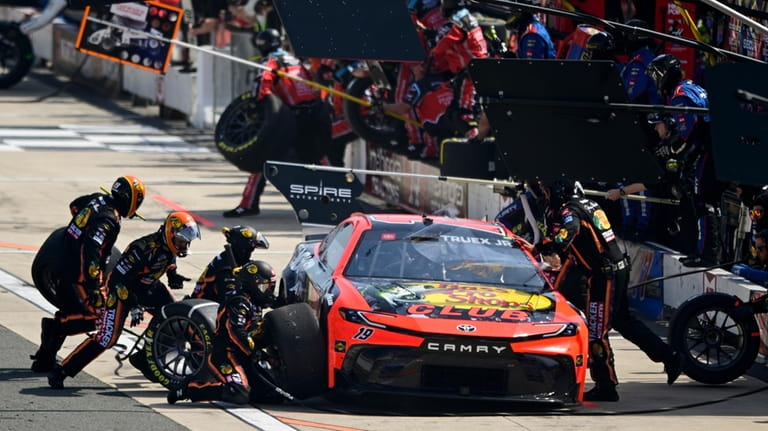Martin Truex Jr. makes a pit stop during a NASCAR...