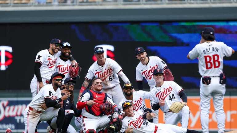 Members of the Minnesota Twins celebrate their team's win over...
