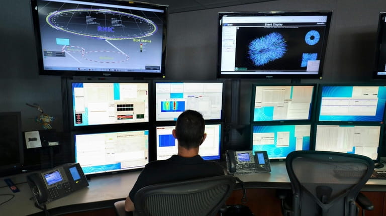 An acceralotor operator monitors data in the control room for...
