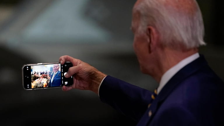 President Joe Biden takes a selfie at Marine Corps Air...