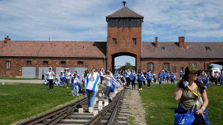 People walk through the former Nazi German death camp of...