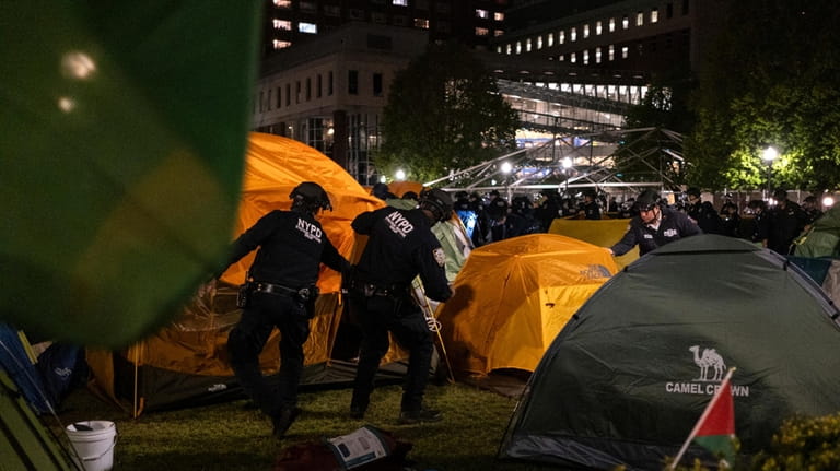 Officers with the New York Police Department raid the encampment...