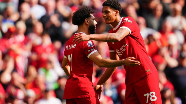 Liverpool's Mohamed Salah is congratulated by Jarell Quansah after scoring...
