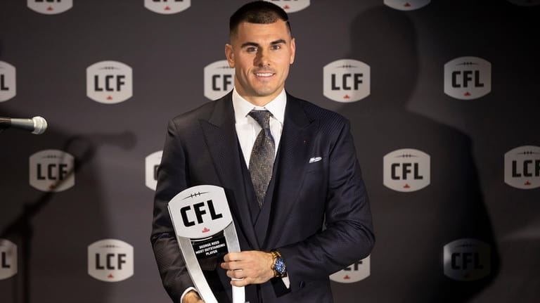 Toronto Argonauts' Chad Kelly poses with his award for Most...