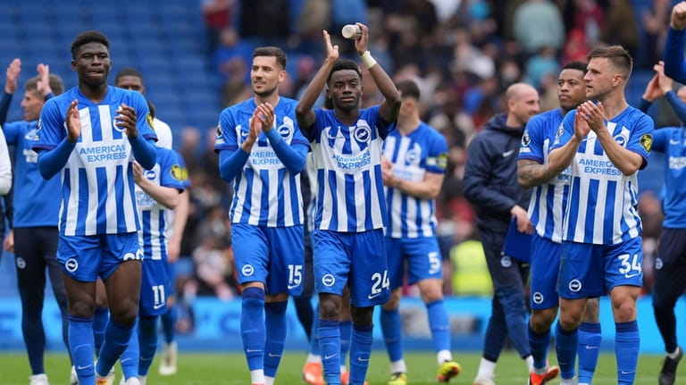 Brighton and Hove Albion players celebrate after winning the Premier...