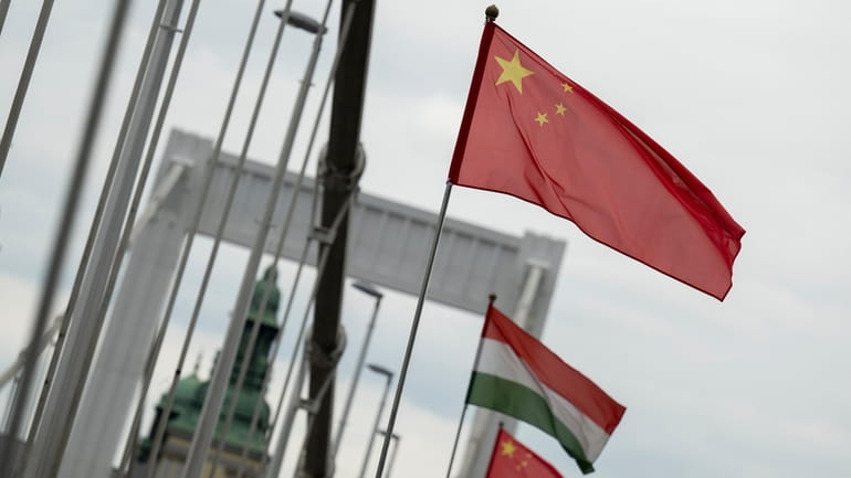 Chinese national flags are placed next to Hungarian flags on...