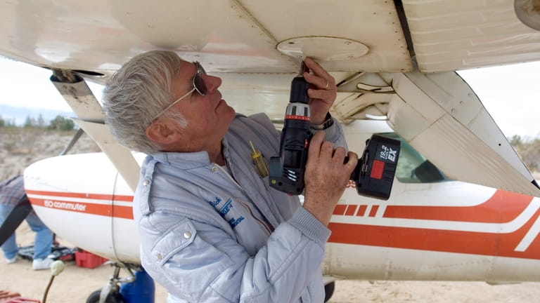 Dick Rutan works on disassembling the wings of his Cessna...