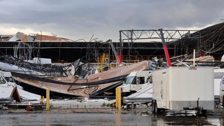 Debris is seen from a damaged FedEx facility after a...