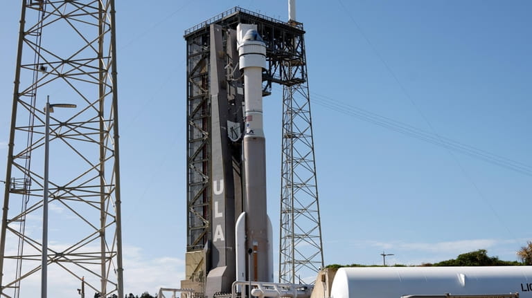 Boeing's Starliner capsule atop an Atlas V rocket stands ready...