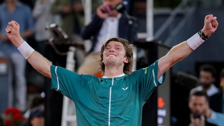 Andrey Rublev, of Russia, celebrates after winning the final match...