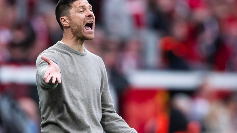 Leverkusen coach Xabi Alonso reacts on the touchline during a...