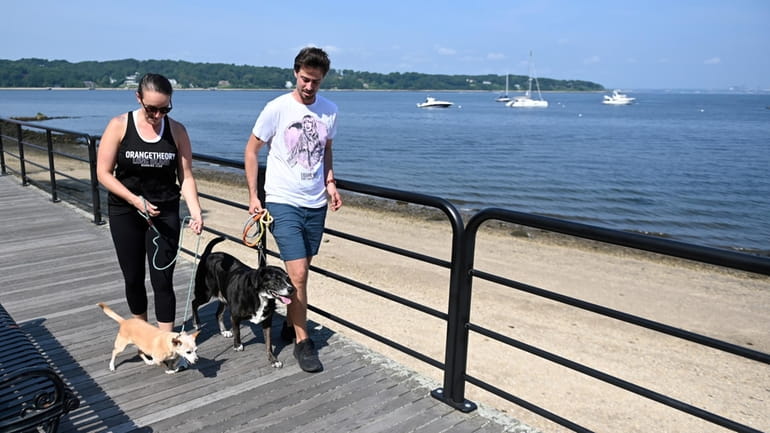 Kerry Heimer and Davis Robins walk on the boardwalk at...