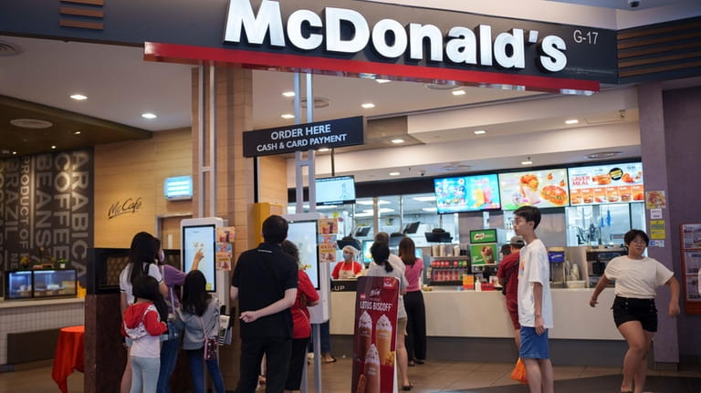 Customers place orders at a McDonald's restaurant at a shopping...