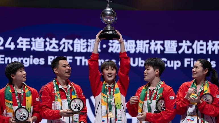 China's Chen Yu Fei holds up the Uber Cup after...