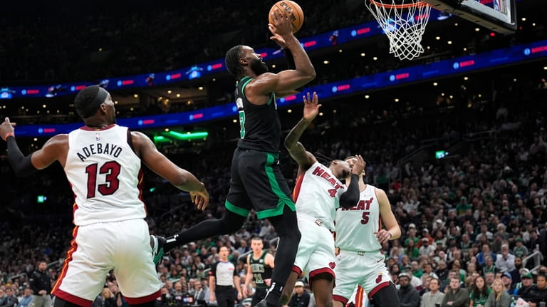 Boston Celtics guard Jaylen Brown (7) drives past Miami Heat...