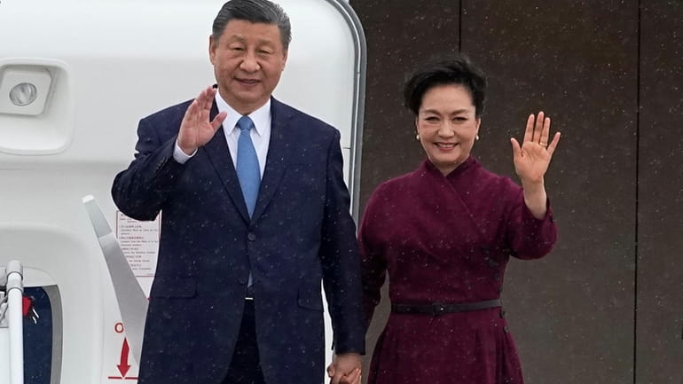 China's President Xi Jinping and his wife Peng Liyuan wave...