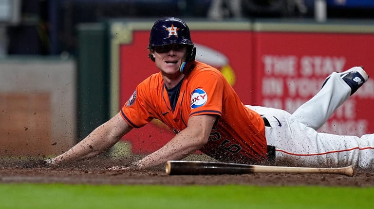 Houston Astros' Jake Meyers scores on a squeeze bunt by...