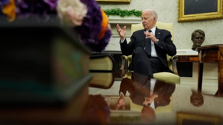 President Joe Biden speaks as he meets in the Oval...
