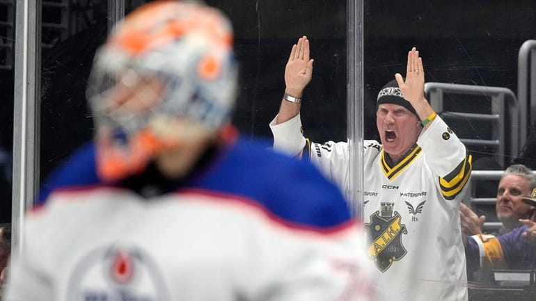 Actor Will Ferrell, right, cheers as Edmonton Oilers goaltender Stuart...