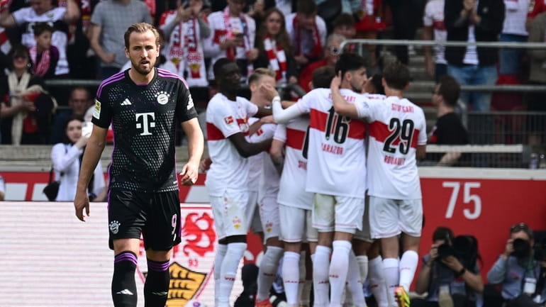 Munich's Harry Kane walks, after Stuttgart scored the opening goal,...