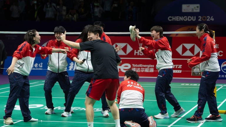 China's Chen Yu Fei holds up a shoe dropped by...