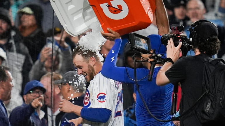 Chicago Cubs' Michael Busch gets doused after his game-winning home...