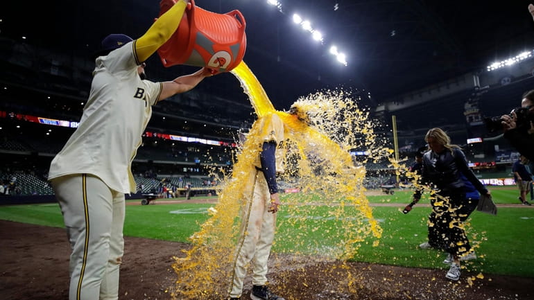Milwaukee Brewers' Tyler Black is dunked by Willy Adames after...