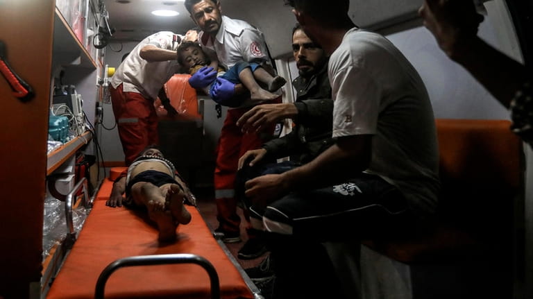 Palestinian medics evacuate wounded children in Israeli bombardment of the...