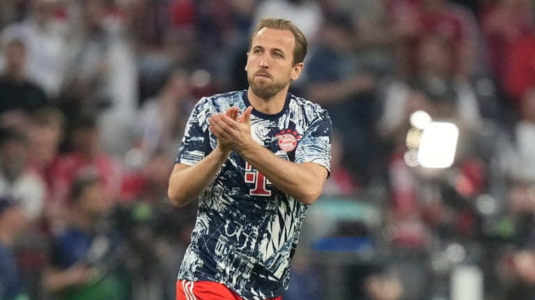 Bayern's Harry Kane applauds fans as he warms up prior...