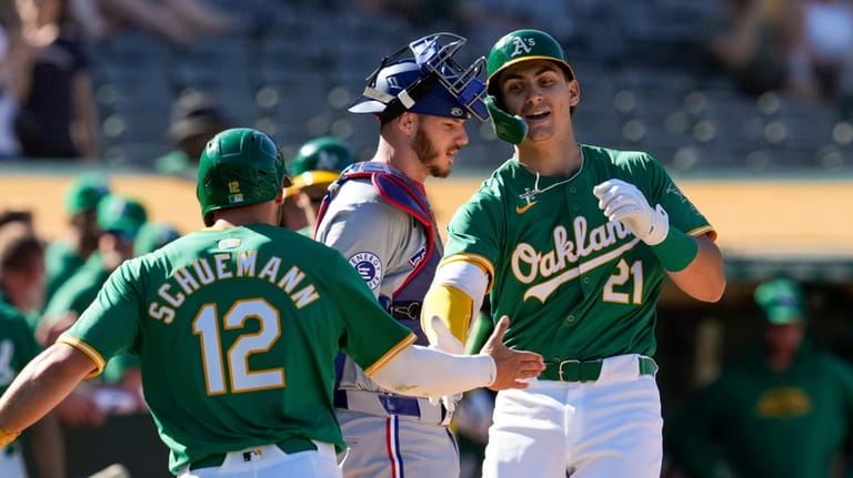 Oakland Athletics' Tyler Soderstrom, right, celebrates with Max Schuemann, left,...