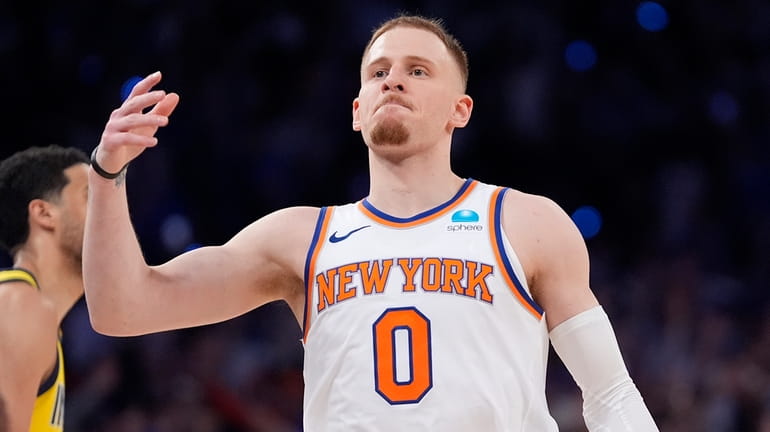 The Knicks' Donte DiVincenzo gestures after making a three-point basket during...